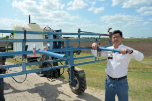 Dr. Juan Enciso, a Texas A&M AgriLife Research irrigation engineer in Weslaco, examines sensors that will one day be mounted on drones to evaluate crops. (AgriLife Communications photo by Rod Santa Ana)
