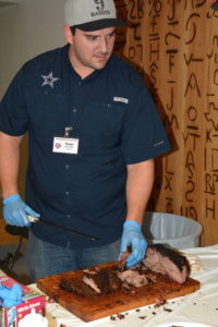 Evan LeRoy, pitmaster from Austin, cooked barbecue beef chuck roll and pork brisket for participants at the Texas Barbecue Town Hall meeting held at Texas A&M University in College Station. (Texas A&M AgriLife Extension Service photo by Blair Fannin)