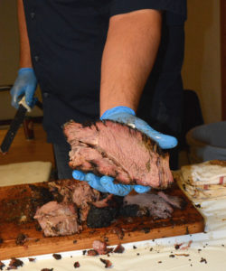 Evan LeRoy, pitmaster from Austin, cooked barbecue beef chuck roll for participants at the Texas Barbecue Town Hall meeting held at Texas A&M University in College Station. (Texas A&M AgriLife Extension Service photo by Blair Fannin)